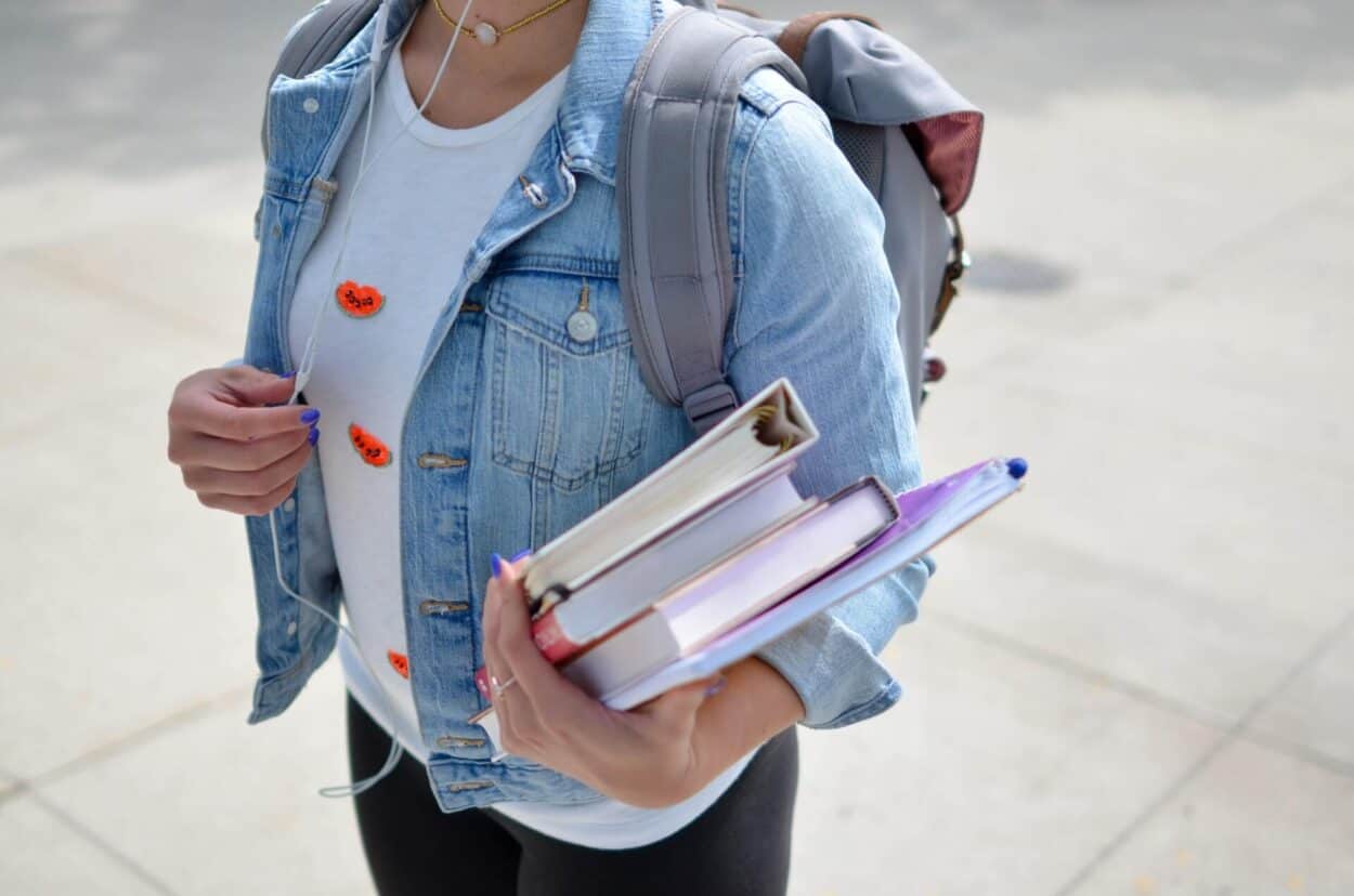 A student holding books going to school